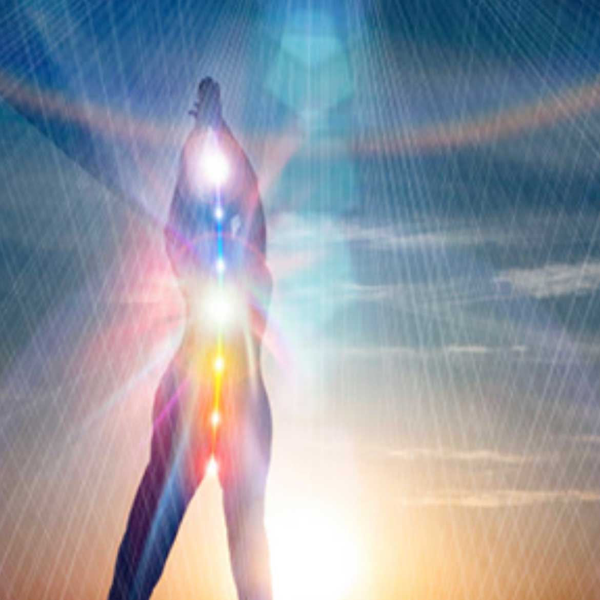 Image of a person with chakras, arms raised
